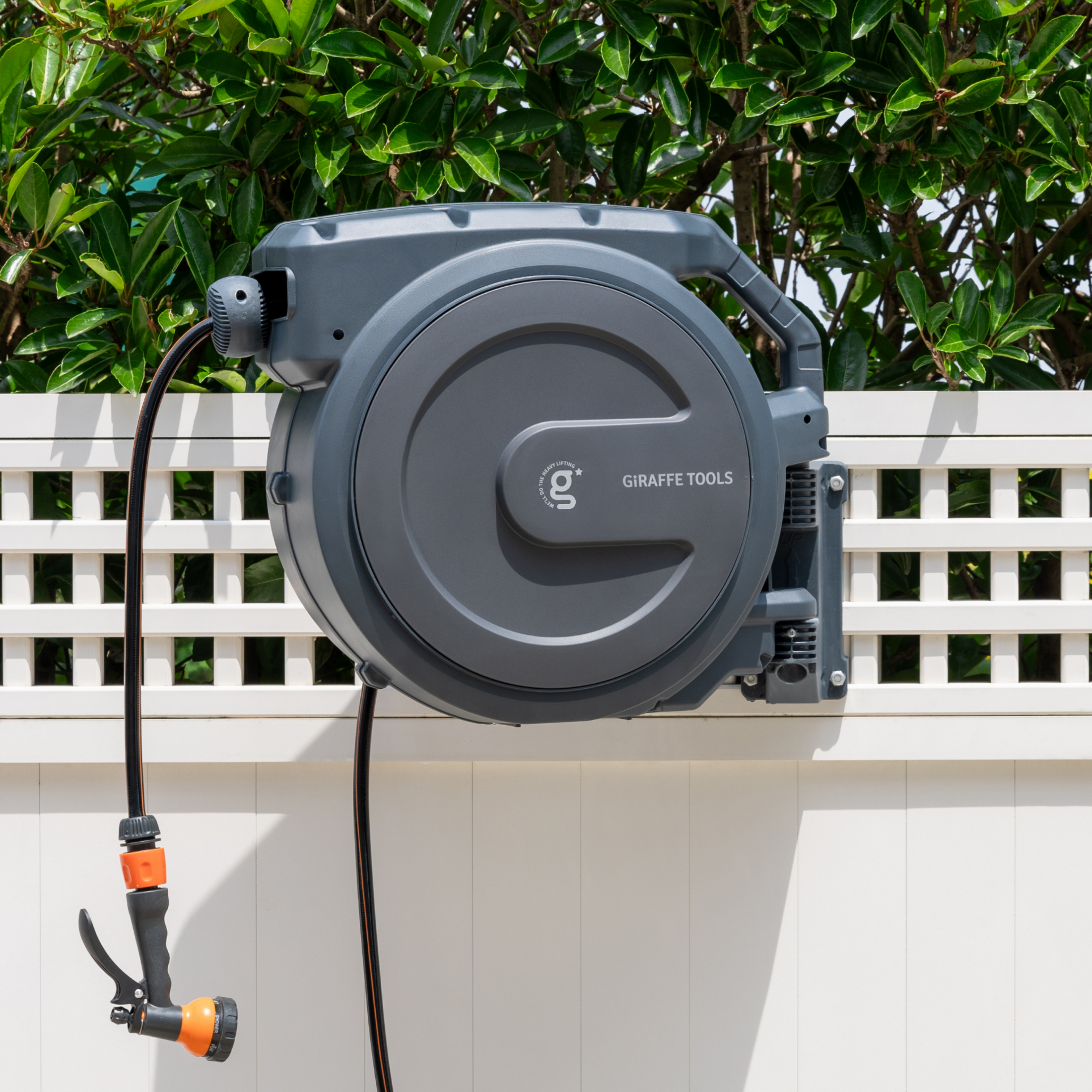 Giraffe Tools Retractable Garden Hose Reel Features a wall-mounted hose reel with a nozzle for neat garden watering.
